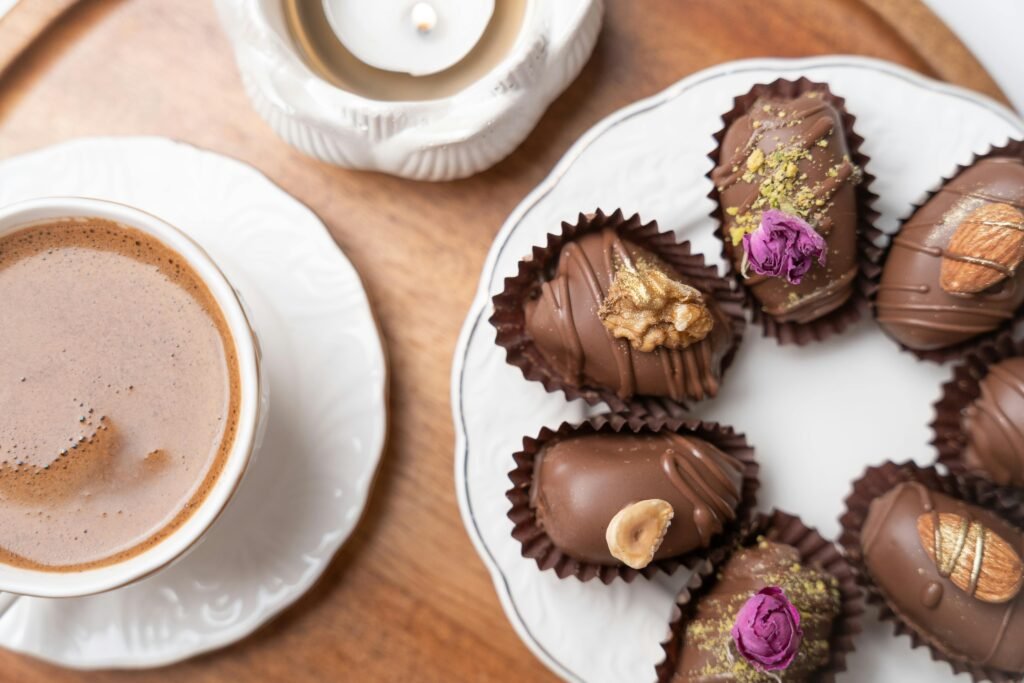 Elegant display of chocolate-covered dates with nuts and coffee, perfect for festive occasions.